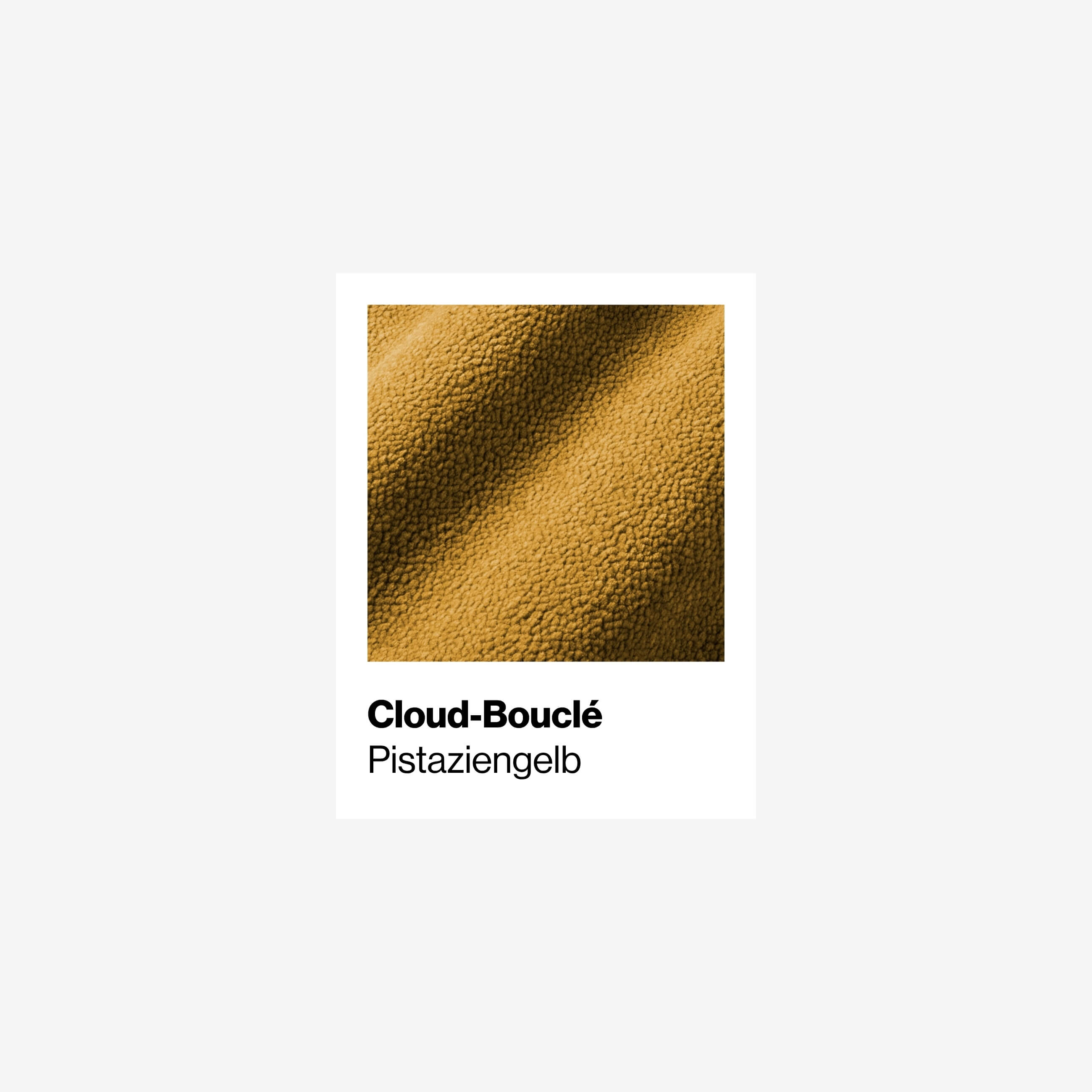 Nahaufnahme eines strukturierten gelb-grünen Stoffes mit der Aufschrift Cloud-Bouclé Pistaziengelb auf weißem Hintergrund.